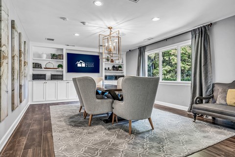 a dining room with a table and chairs and a large window at Trophy Club at Bellgrade, Midlothian, VA, 23113