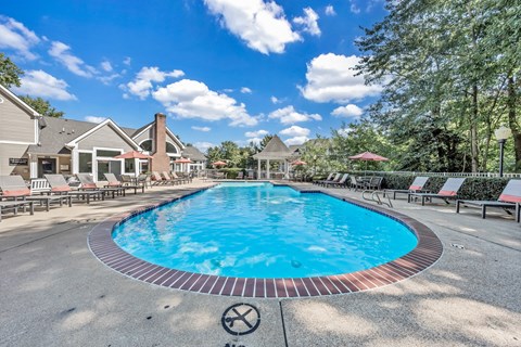 a resort style pool with chairs around it and houses in the background at Trophy Club at Bellgrade, Midlothian, VA, 23113