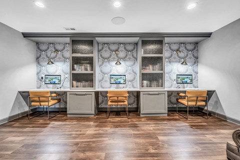 an office space with two desks and chairs and a counter with two computers at Trophy Club at Bellgrade, Midlothian, VA, 23113