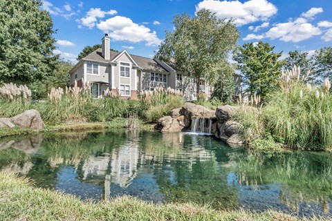 a pond with a house in the background at Trophy Club at Bellgrade, Midlothian, VA, 23113