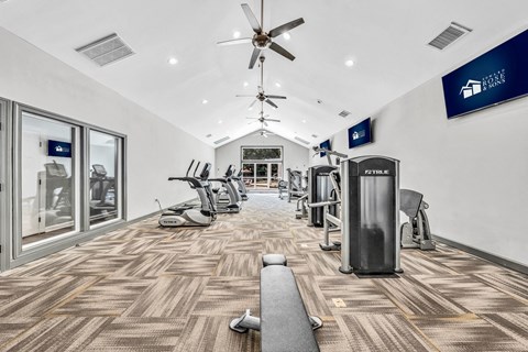 a gym with cardio machines and a ceiling fan at Trophy Club at Bellgrade, Midlothian, VA, 23113