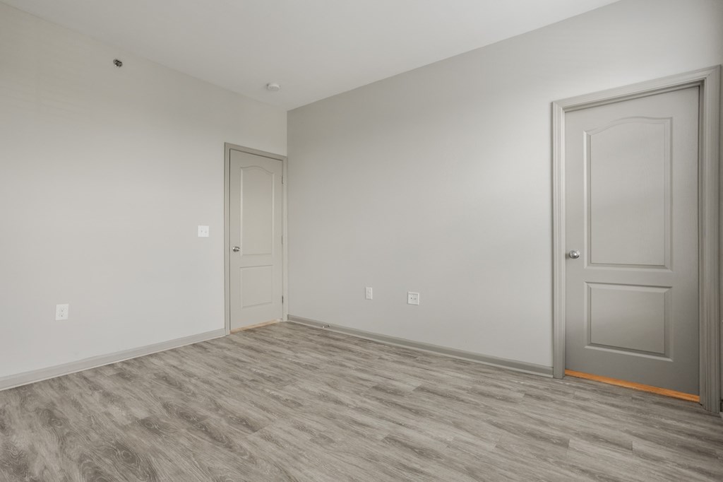 an empty room with a door and a white wall at The Avenue at Polaris Apartments, Columbus, OH