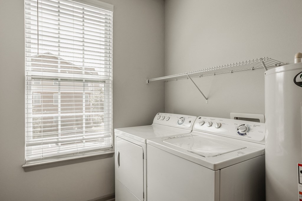 a white washer and dryer in a room with a window and a white at The Avenue at Polaris Apartments, Columbus, OH