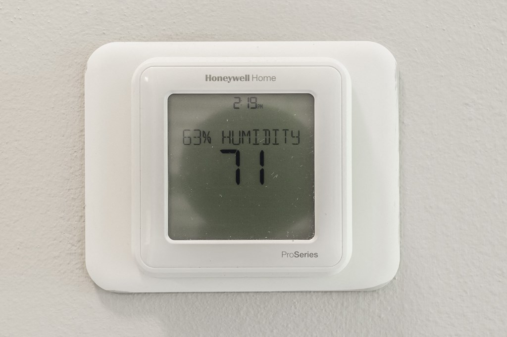 a white thermostat on a wall with an 11 on it at The Avenue at Polaris Apartments, Columbus, OH