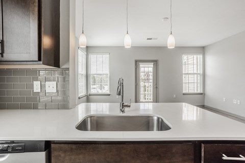 a kitchen with white counter tops and a sink