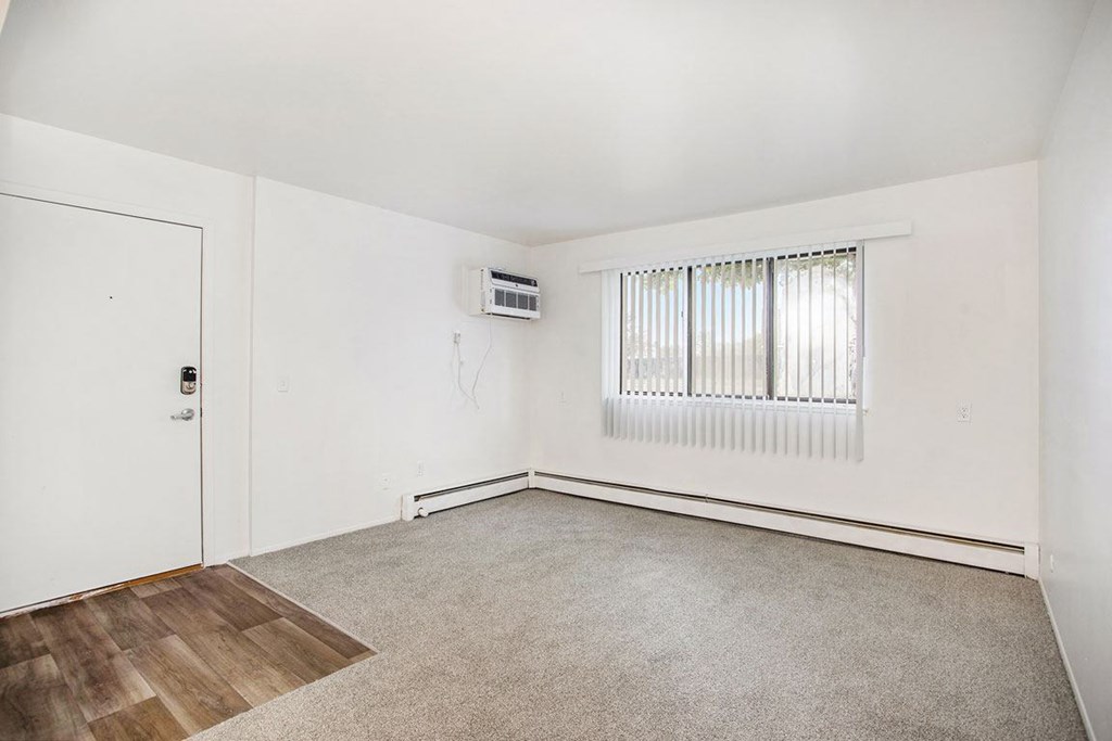 living room with a large window at Fairlane Apartments in Springfield, MI