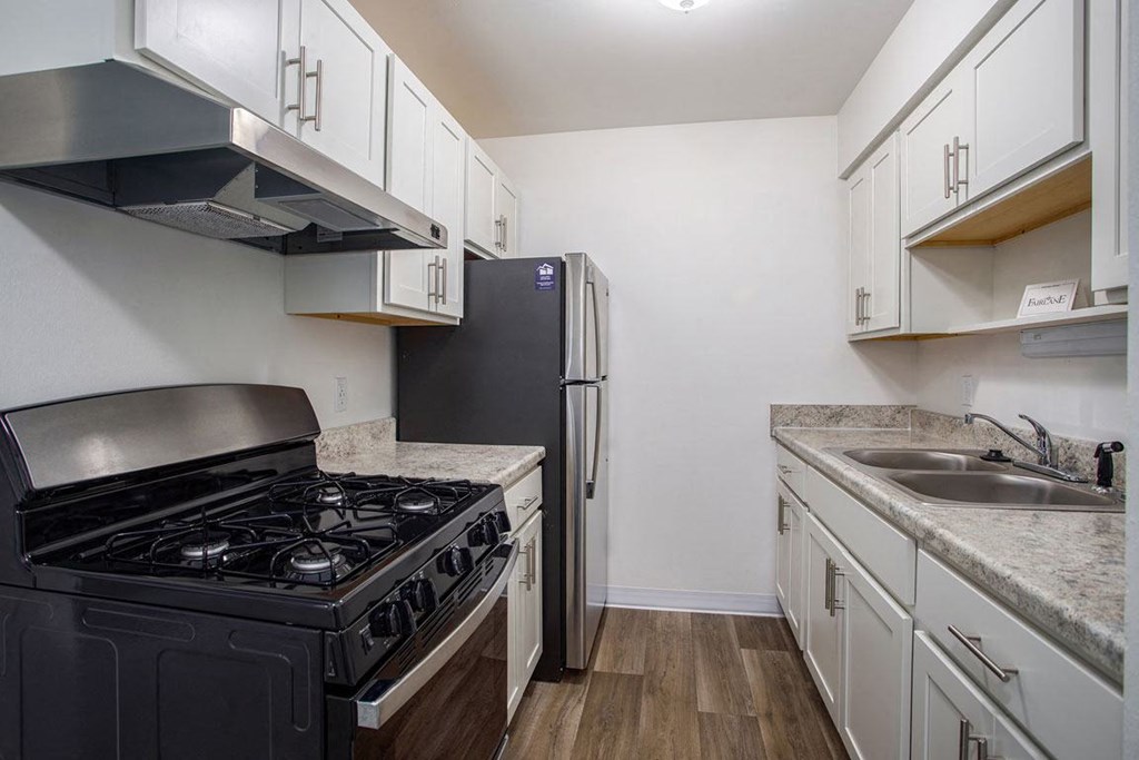a kitchen with stainless steel appliances at Fairlane Apartments in Springfield, MI