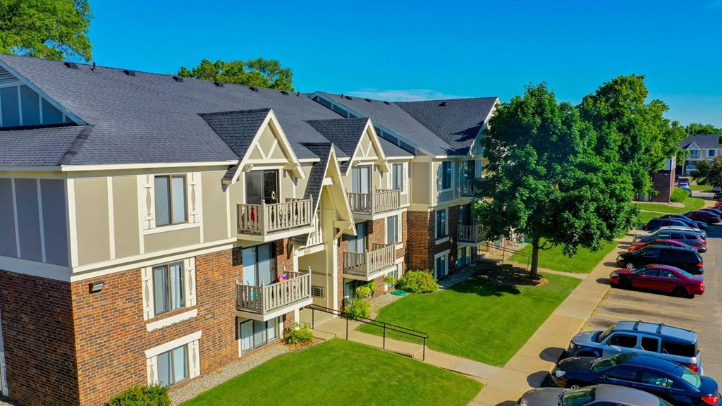 an aerial view of an apartment building with cars parked in front of it at Fairlane Apartments, Springfield, MI, 49037