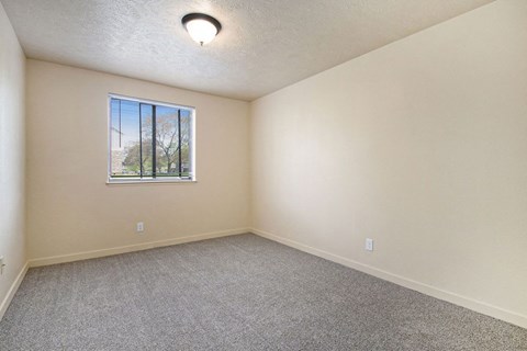 bedroom with carpet and a window at Old Farm Apartments, Elkhart, Indiana