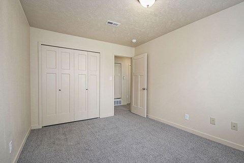 bedroom with a large closet and carpeting at Old Farm Apartments, Elkhart, Indiana