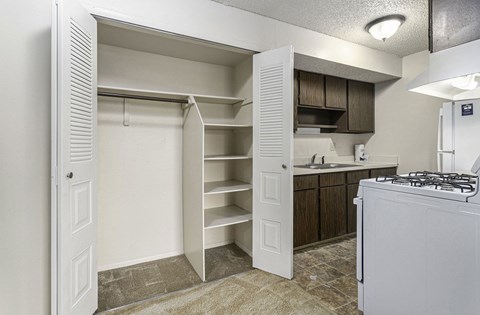 a kitchen with a large closet with shelving at Old Farm Apartments, Elkhart, Indiana