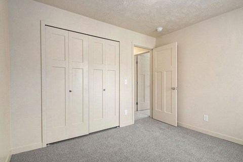 a large bedroom with closet doors at Old Farm Apartments, Elkhart, Indiana