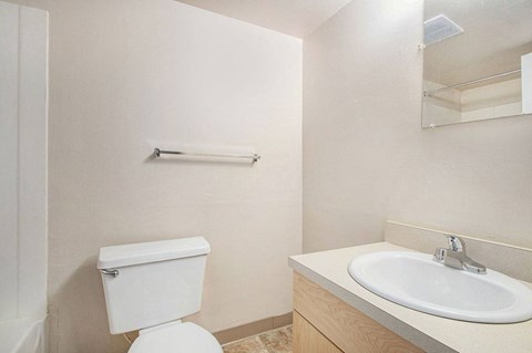 a studio bathroom with a sink toilet and a mirror at Old Farm Apartments, Elkhart, Indiana