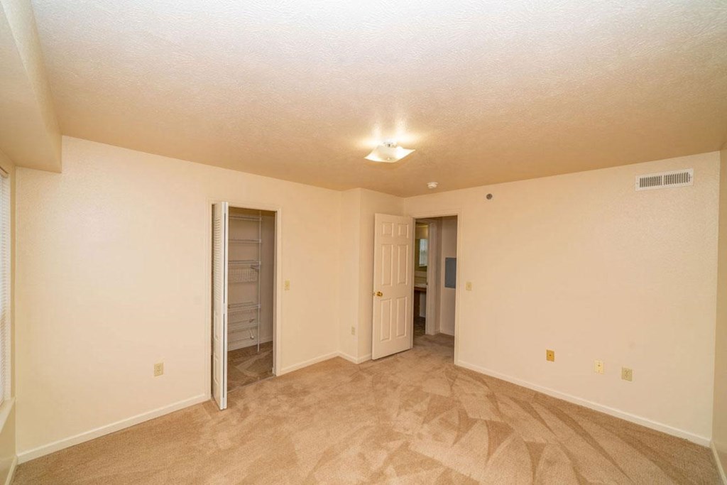 bedroom with a walk-in closet with wardrobe organizers at Foxwood and The Hermitage, Portage, MI