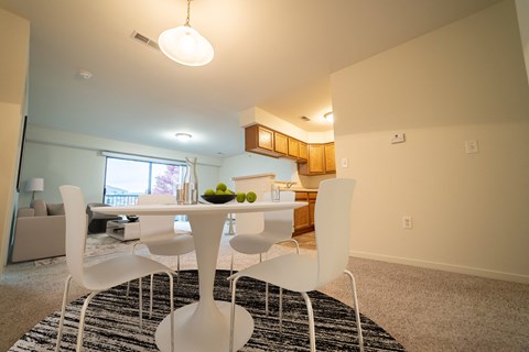 a dining room with a white table and chairs