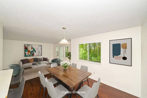 a living room and dining room with a table and chairs