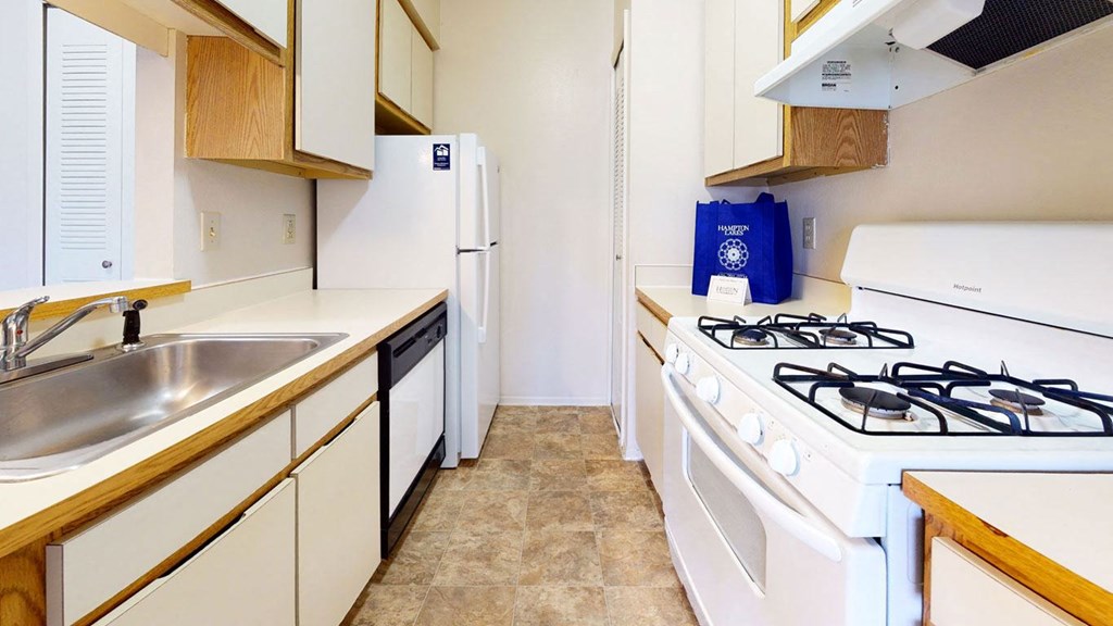 Gas Range and Dishwasher In Kitchen at Hampton Lakes Apartments, Walker, MI