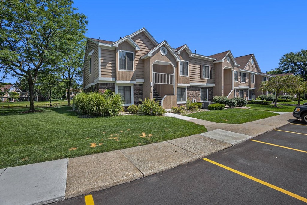 Landscaped grounds with walkways at Hampton Lakes Apartments, Walker, MI, 49534