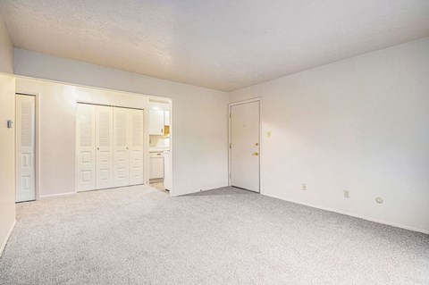 a bedroom with white walls and carpet at Hickory Village Apartments, Indiana