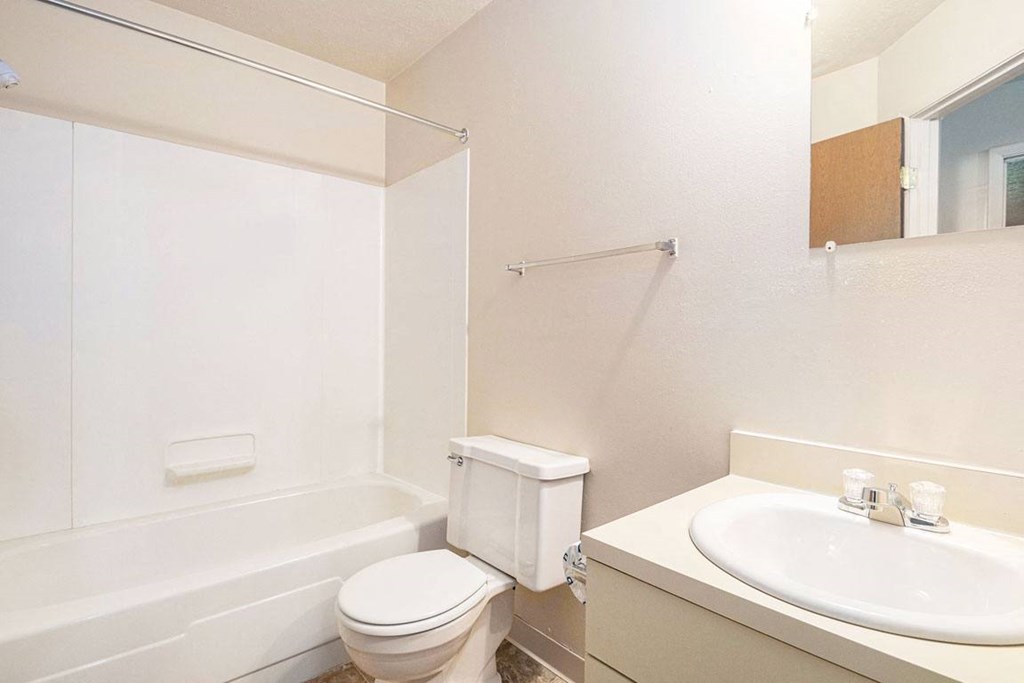 a bathroom with a sink toilet and bathtub at Hickory Village Apartments, Mishawaka, Indiana