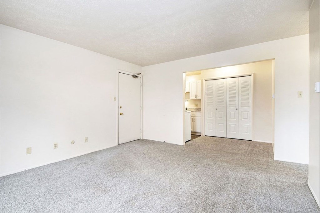 a bedroom with white walls and carpet at Hickory Village Apartments, Mishawaka, IN