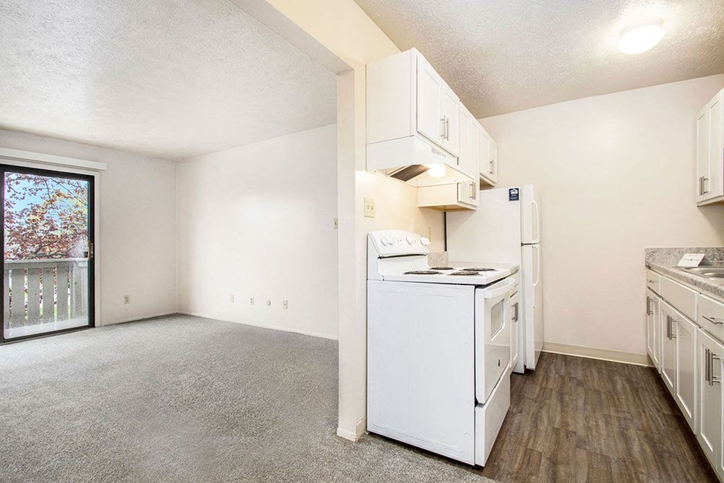 a kitchen with white appliances and white cabinets at Hickory Village Apartments, Mishawaka, IN