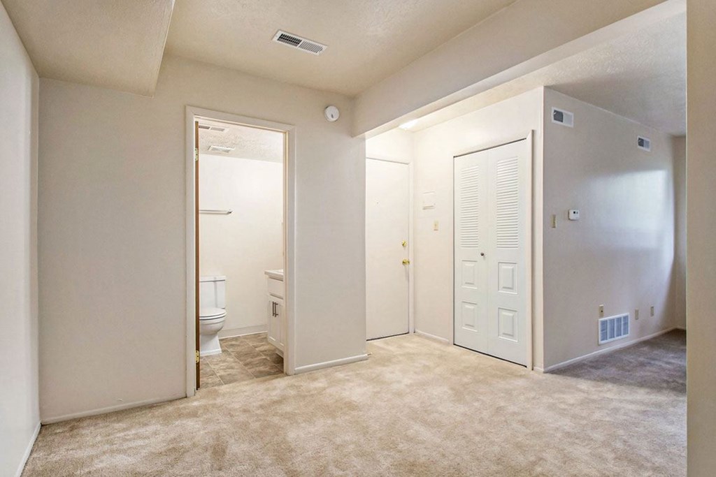 a bedroom with a toilet and a closet at Hickory Village Apartments, Indiana
