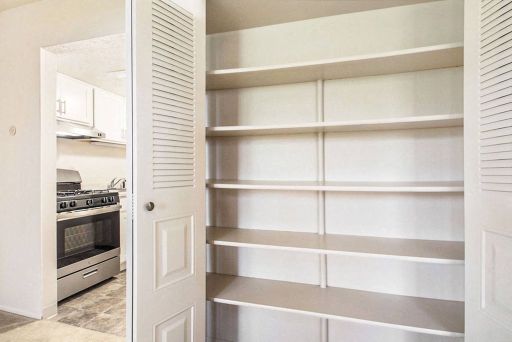 a kitchen with a white door and white shelves at Hickory Village Apartments, Indiana, 46545