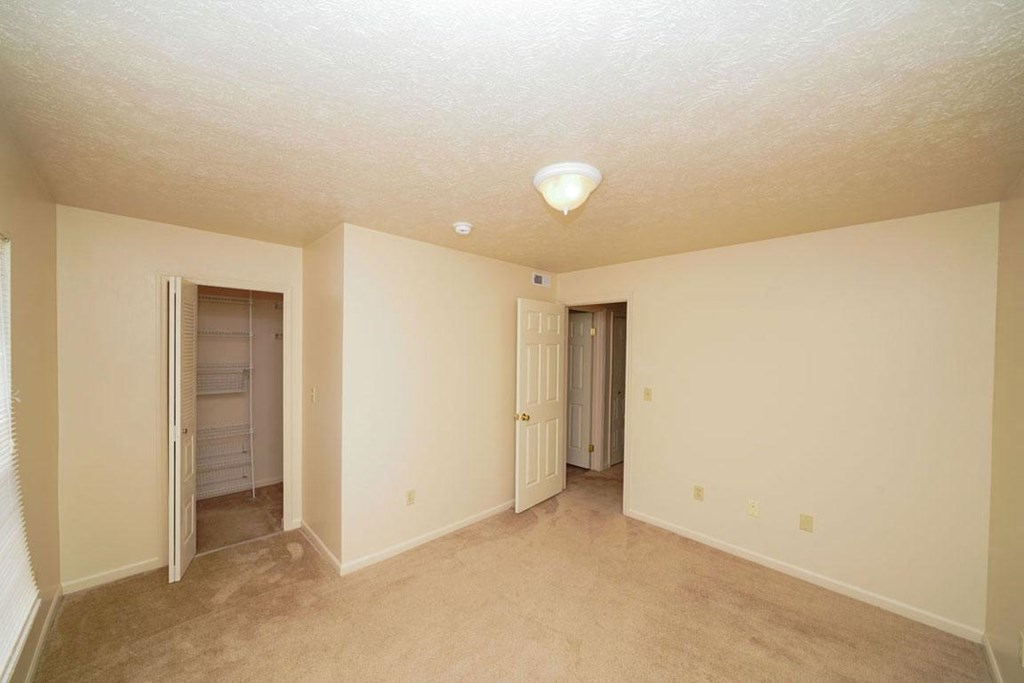 Bedroom with a walk-in closet at Huntington Cove Apartments, Merrillville