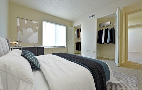 Master bedroom with walk-in closets and window at Heatherwood Apartments, Grand Blanc