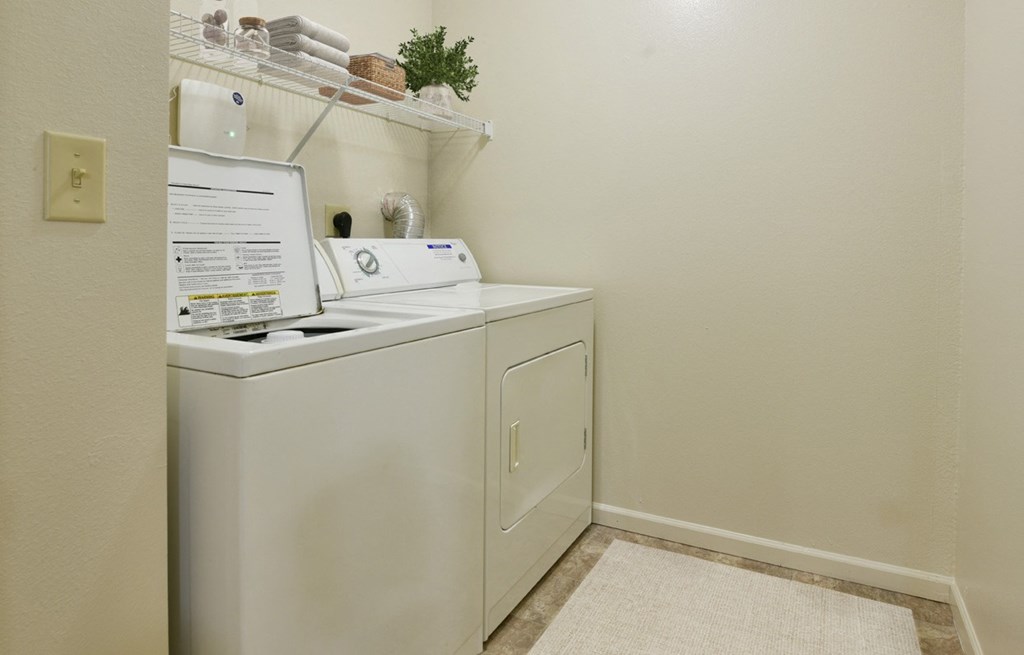 a washer and dryer in our resident laundry room at Heatherwood Apartments, Grand Blanc