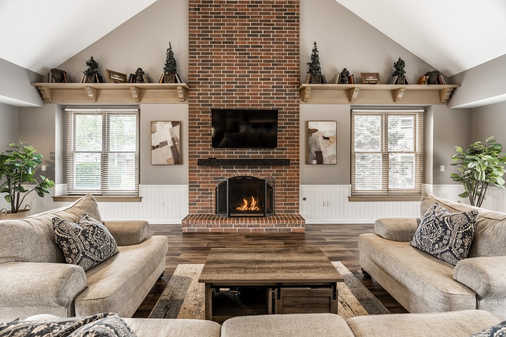 A cozy living room with a fireplace and a couch
