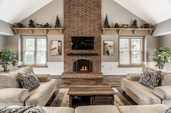 A cozy living room with a fireplace and a couch.