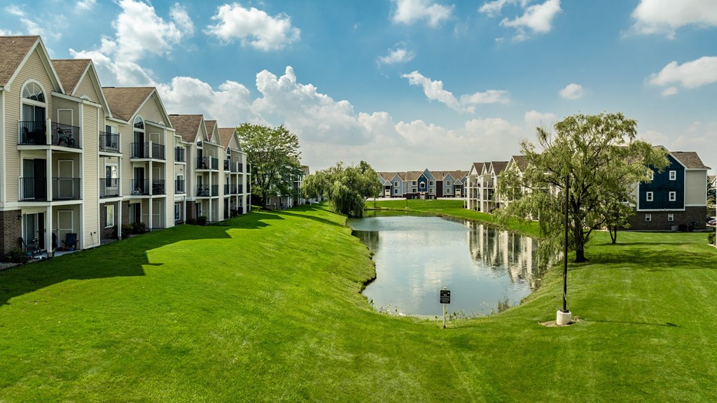 A row of houses with a pond in the foreground