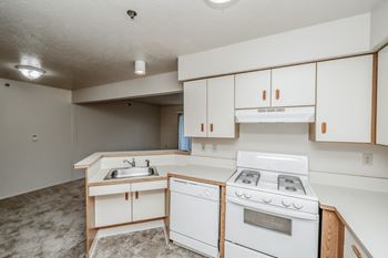 A kitchen with white appliances and cabinets.