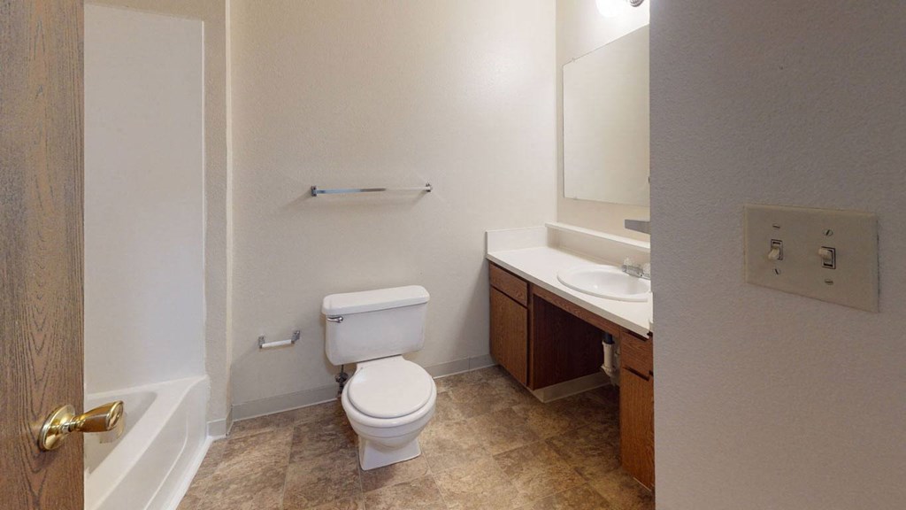 a bathroom with a toilet and a sink at Indian Lakes Apartments, Mishawaka, Indiana