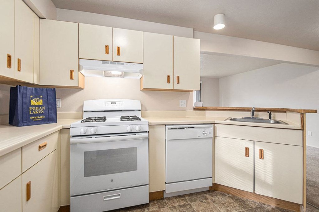 a kitchen with a breakfast bar at Indian Lakes Apartments, Mishawaka