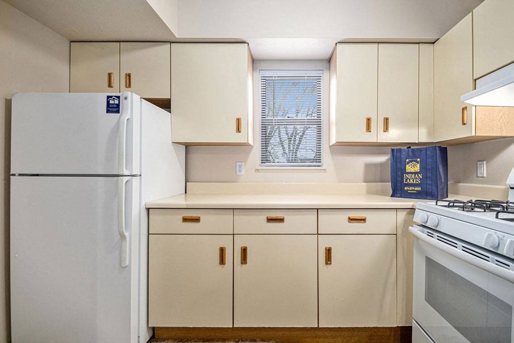 a kitchen with white appliances and a window at Indian Lakes Apartments, Indiana