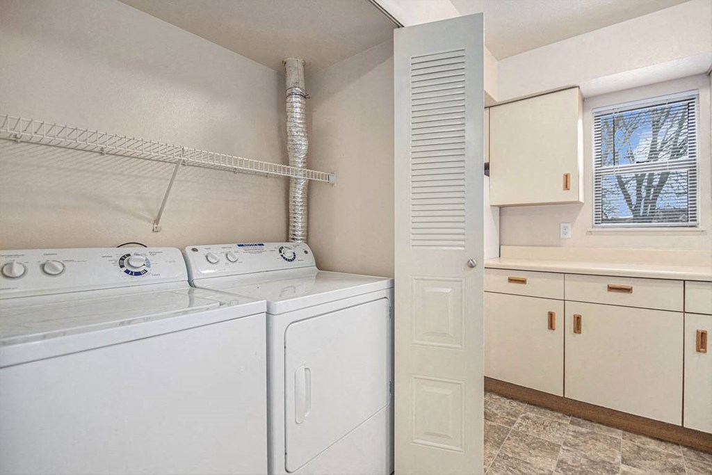 end kitchen with a washer and dryer and a window at Indian Lakes Apartments, Mishawaka