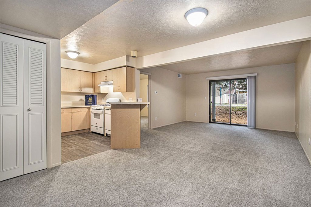 Two bedroom one bath living room with a door to patio at Indian Lakes Apartments, Mishawaka, 46545