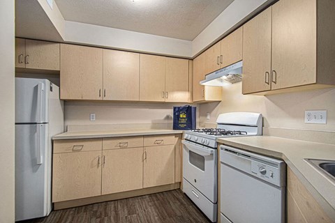 a kitchen with white appliances and wooden cabinets