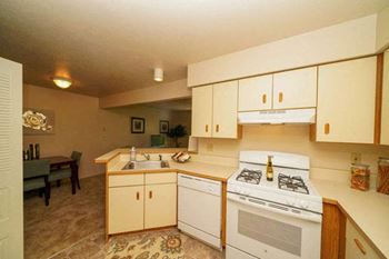 Kitchen With Breakfast Bar at Indian Lakes Apartments in Mishawaka, IN