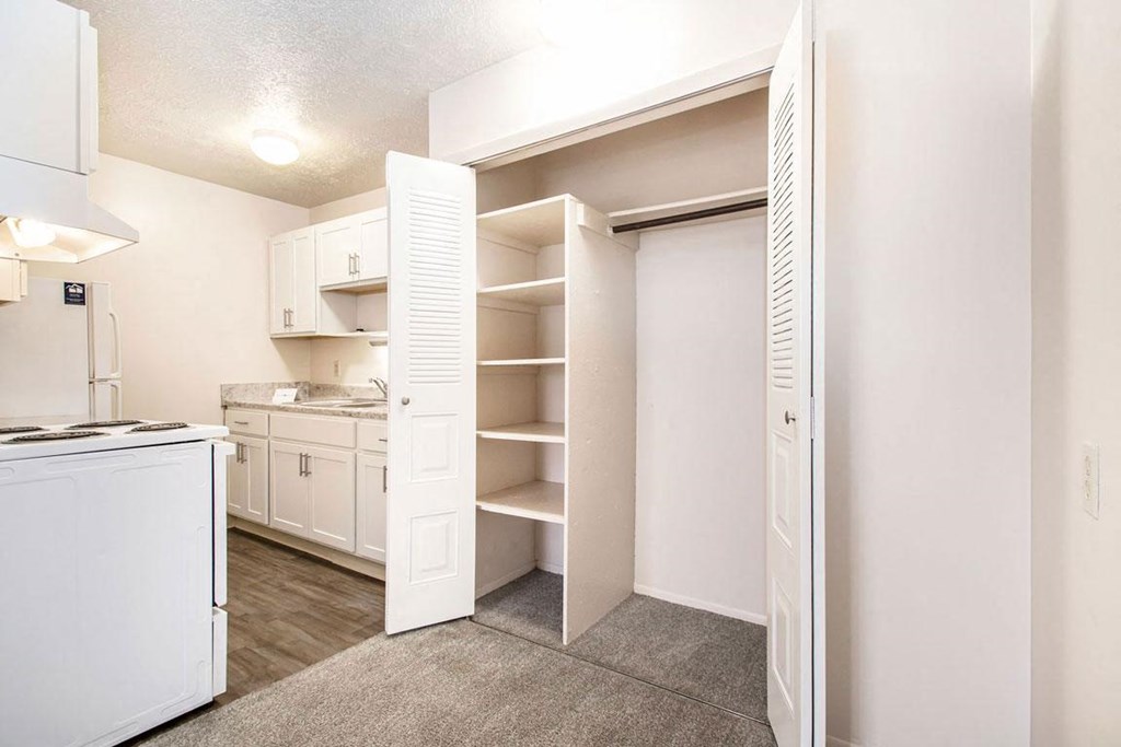 a renovated kitchen with white appliances and a closet at Irish Hills Apartments, South Bend, IN, 46614