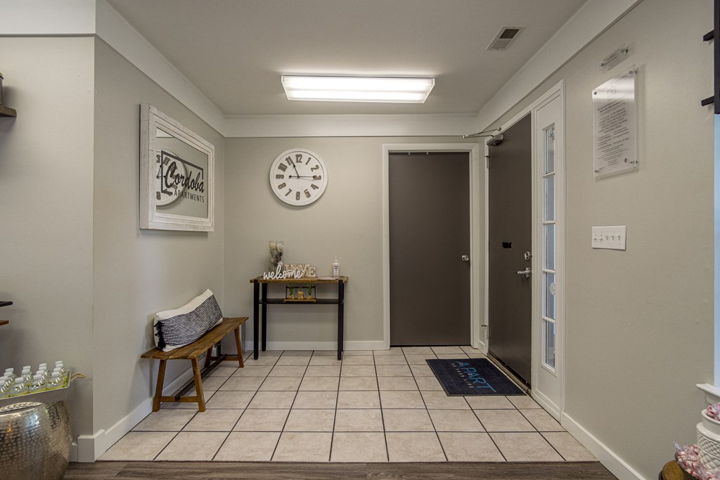a waiting room with a bench and a clock on the wall at Cordoba Apartments, Farmington Hills, 48334