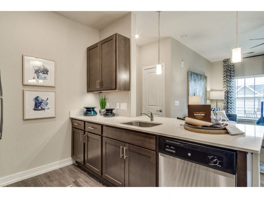 Kitchen with quartz countertops and stainless steel appliances at Montgomery Place Apartments, Montgomery, 60538
