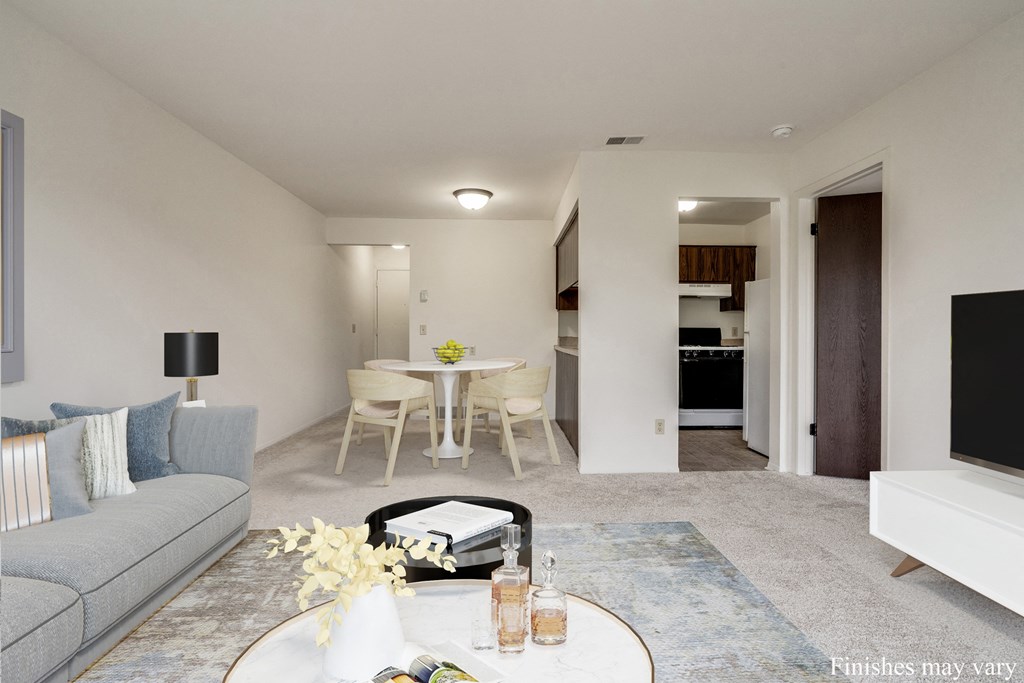 a living room with a couch and a table in front of a tv at The Landings Apartments, Westland at The Landings Apartments, Michigan