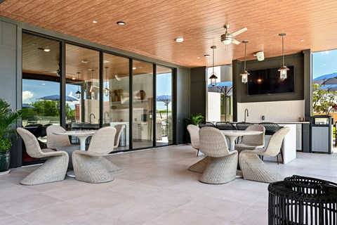 A modern outdoor dining area with a wooden ceiling and glass walls at Ironwood Flats Apartments, Brandon, 33511