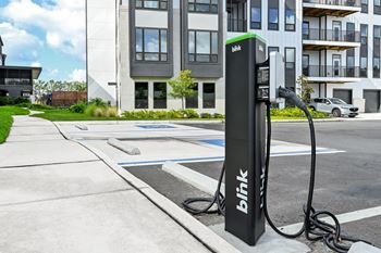 A black charging station with the word at Ironwood Flats Apartments, Brandon, 33511
