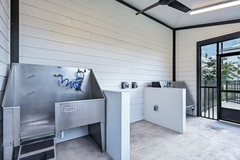 A modern kitchen with a stainless steel sink and a white countertop at Ironwood Flats Apartments, Brandon, FL, 33511