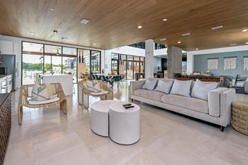 A modern living room with a wooden ceiling and a large window at Ironwood Flats Apartments, Brandon, FL, 33511
